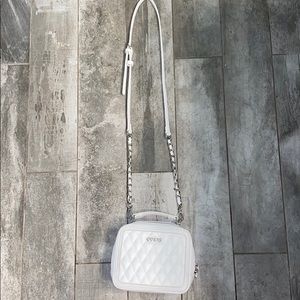 This is a vintage white GUESS bag.
